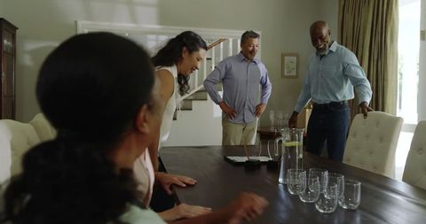 Diverse Seniors Enjoying Home Celebration Gathering at Dining Table