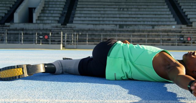 Athlete with Prosthetic Leg Stretching on Race Track - Download Free Stock Images Pikwizard.com