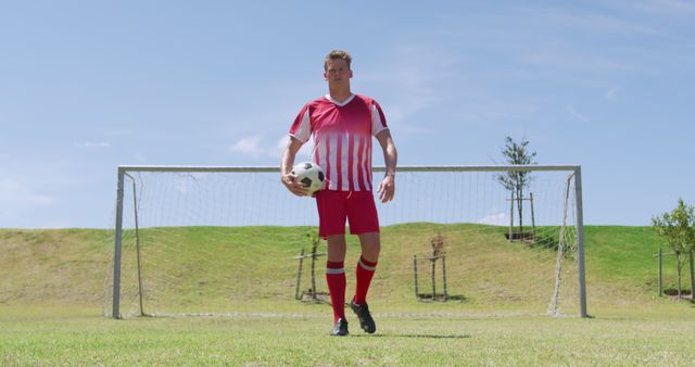 Confident Male Soccer Player Holding Ball on Field - Download Free Stock Images Pikwizard.com