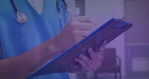 Healthcare professional noting patient information in clinical setting