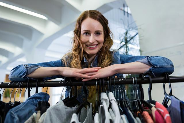 Woman leaning on a clothes rack - Download Free Stock Photos Pikwizard.com