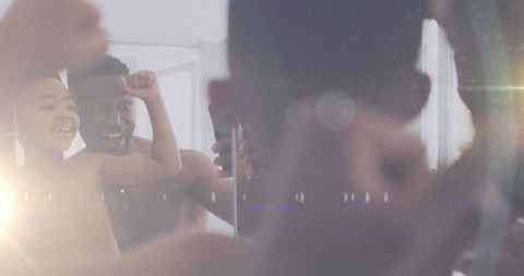 Father and son facing mirror enjoying quality time together