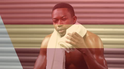 African American Athlete Resting with Towel in Gym