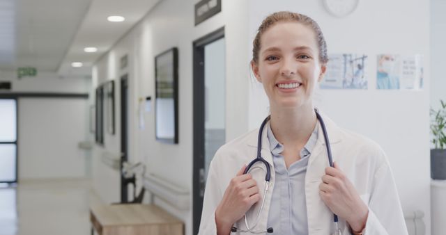 Confident Young Female Doctor Standing in Hospital Hallway - Download Free Stock Images Pikwizard.com