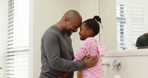 Father and daughter sharing heartwarming moment in bathroom