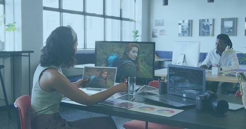 Creative professionals reviewing photography in modern office