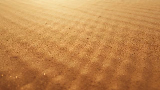 Golden Sand Ripples in Desert Landscape Creating Flowing Patterns