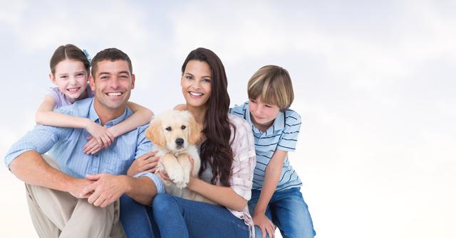 Smiling family with two young children holding and petting a cute puppy in pleasant outdoor surroundings. Ideal for advertisements, family-related content, pet care promotions, or articles about family life, outdoor activities, and building family bonds.