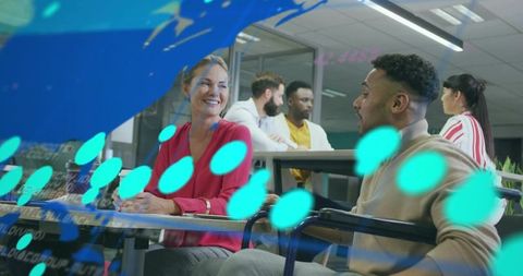 Smiling colleagues collaborating and brainstorming in modern coworking space with glass partition