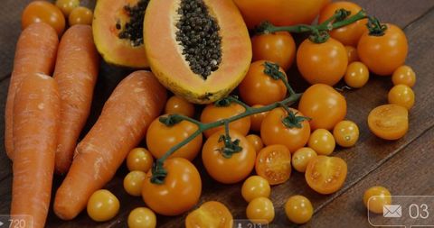 Fresh summer produce assortment featuring papaya and tomatoes