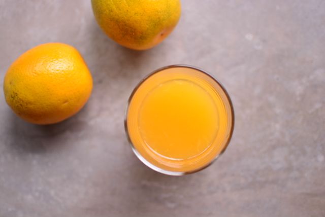 Fresh Orange Juice with Whole Oranges on Stone Table - Download Free Stock Photos Pikwizard.com