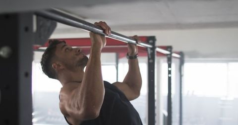 Man Performing Pull-Ups on Gym Bar for Fitness and Strength - Download Free Stock Images Pikwizard.com