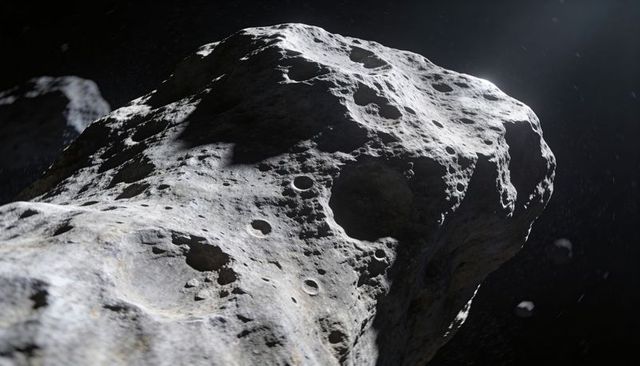 Close-up sunlit asteroid surface revealing deep craters, pitted regolith and rugged ridges
