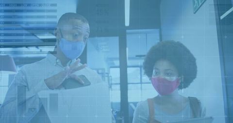 Masked Colleagues Collaborating with Digital Analytics Overlay in Modern Coworking Office