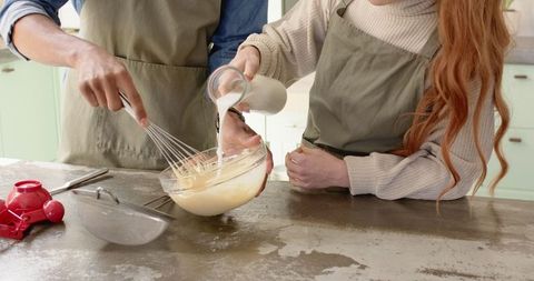 Couple Preparing Homemade Batter in Home Kitchen