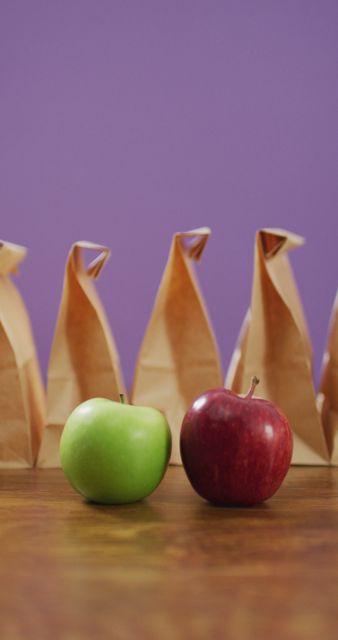 Red and Green Apples with Packed Lunches Against Purple Background - Download Free Stock Images Pikwizard.com