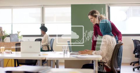 Global business team analyzing financial data in office setting