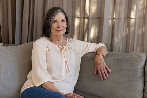 Senior Woman Relaxing on Sofa at Home in Casual Attire