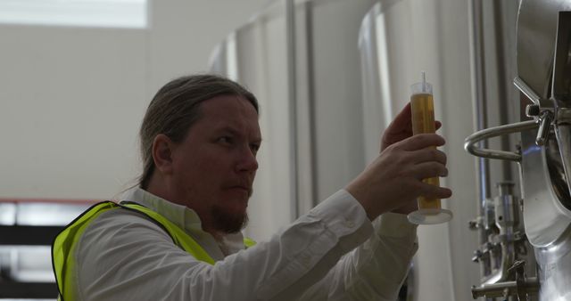 Brewery Worker Inspecting Beer Sample in Fermentation Tank - Download Free Stock Images Pikwizard.com