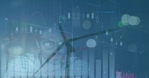 Businessman Analyzing Financial Data with Wind Turbines Overlay