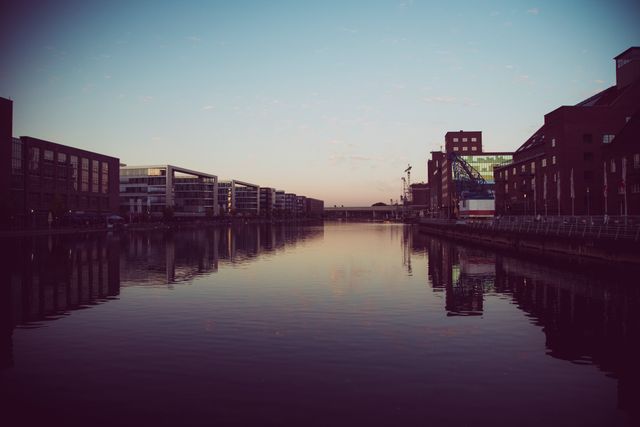 Urban Waterfront at Sunset with Reflections on Still Water - Download Free Stock Images Pikwizard.com