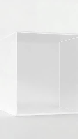 Rotating camera revealing minimalist white display box with vertical divider for product showcase