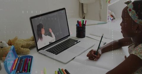 Girl studying remotely during virtual lesson on laptop with colorful stationery