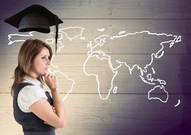 Businesswoman in professional attire with graduation cap imposed above her while standing against a world map drawn on a wooden background. Ideal for use in contexts that deal with education, global career choices, international opportunities, professional growth, and academic success.