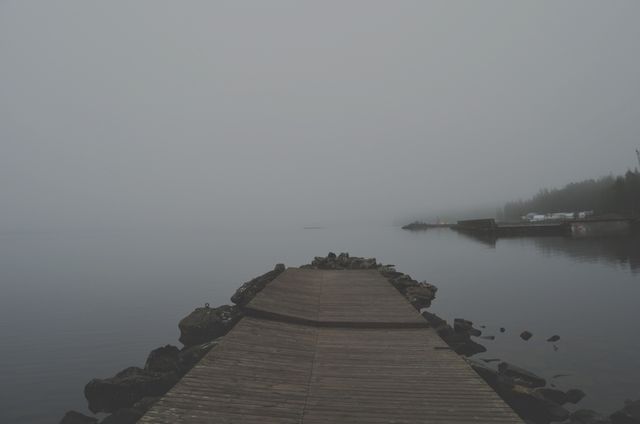 Misty Morning on Calm Lake with Wooden Dock and Rocks - Download Free Stock Images Pikwizard.com