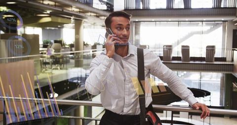 Businessman Leaning on Railing and Talking on Phone with Digital Charts Overlay