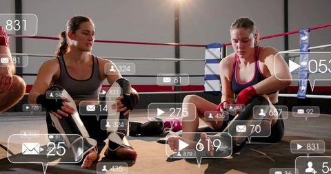 Female boxers resting and wrapping hands in ring with social media overlay graphics