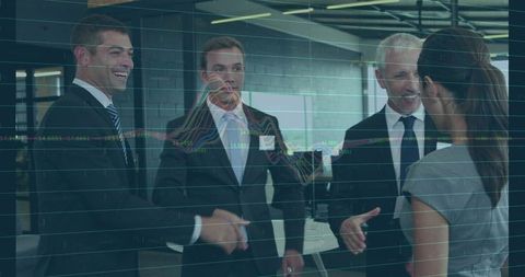 Executives shaking hands with financial chart overlay in modern office networking