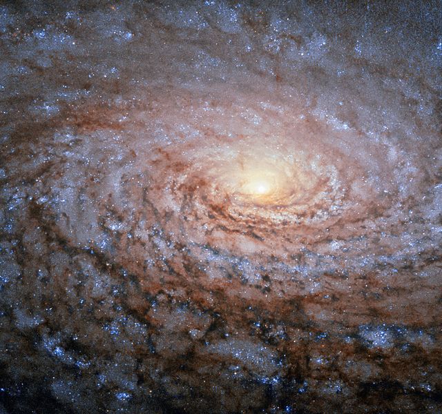 Messier 63, also known as the Sunflower Galaxy, displays beautifully detailed spiral arms resembling sunflower patterns. Captured by the NASA/ESA Hubble Space Telescope, the image shows bright blue-white stars in its arms. Discovered in 1779 by Pierre Mechain, Messier 63 is in the constellation Canes Venatici, about 27 million light-years from Earth. Ideal for educational content in astronomy, presentations and blogs about space, or publications on galactic structures and formations.