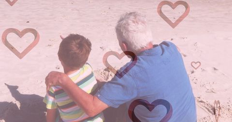 Grandfather and Grandson Enjoying Beach Time With Heart Overlay