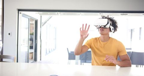 Man immersed in virtual reality at home with vr headset