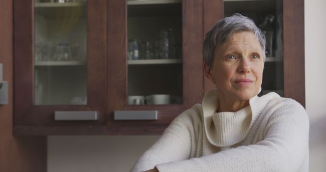 Pensive Mature Woman Sitting in Modern Kitchen - Download Free Stock Images Pikwizard.com