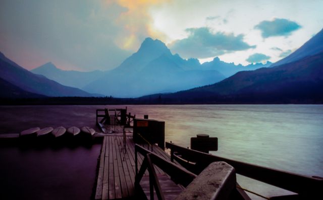 Serene Sunrise Over Calm Mountain Lake with Dock - Download Free Stock Photos Pikwizard.com