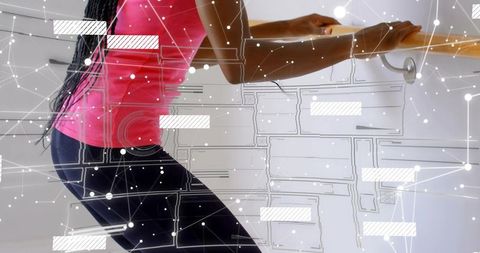 Female Dancer Leaning on Barre Holding Balance During Workout with Futuristic Data Overlay