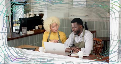 Team of baristas collaborating at coffee shop counter