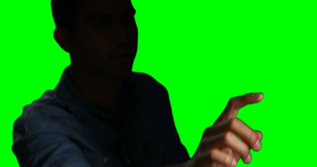 Silhouette of Person Touching Virtual Interface with Green Screen Background - Download Free Stock Images Pikwizard.com