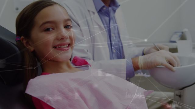 This video shows a happy girl giving thumbs up while sitting in a dental chair at a clinic. There are digital network connections overlaying the scene, suggesting modern technology. This video is suitable for illustrating advanced dental care, children’s health, technology integration in healthcare, and positive dental experiences.