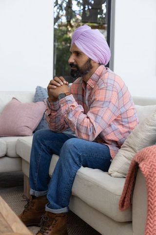 Indian Man with Turban Relaxing Indoors With Focused Expression