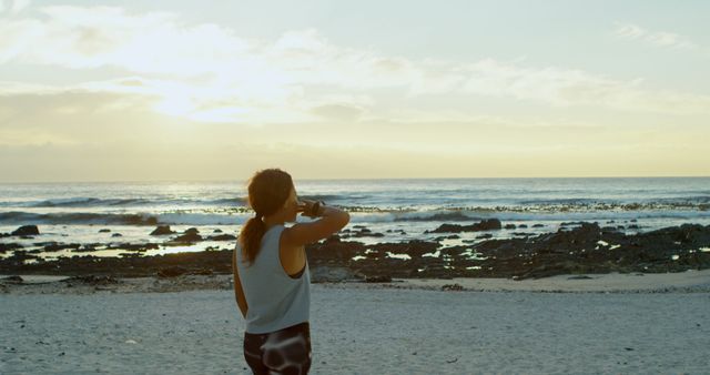 Woman Drinking Water and Looking at Sunrise on Ocean Beach - Download Free Stock Images Pikwizard.com