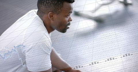 Leaning man wearing white tee with digital data overlay showing fitness analytics and focus