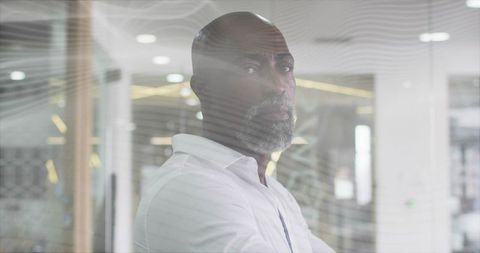 Business executive posing behind stylish glass partition