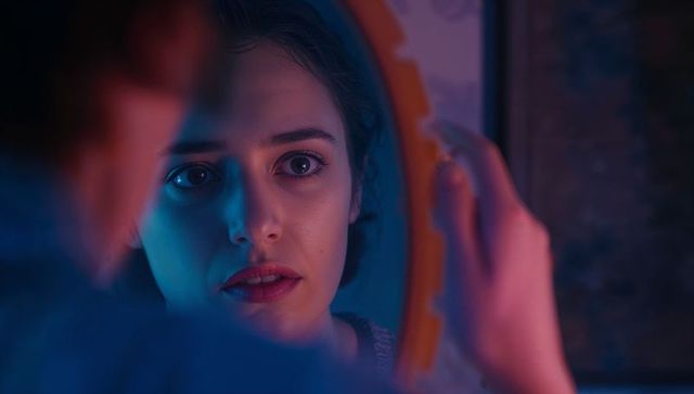 Ethereal Woman Reflection in Dimly Lit Mirror