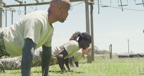 Diverse Soldiers Training at Army Obstacle Course in Sunlight