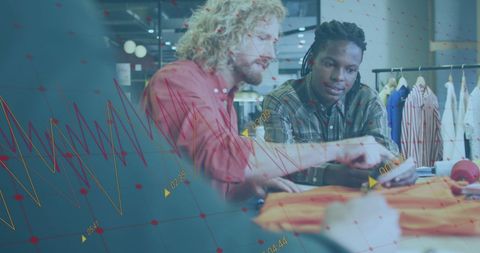 Fashion designers analyzing business data in contemporary studio