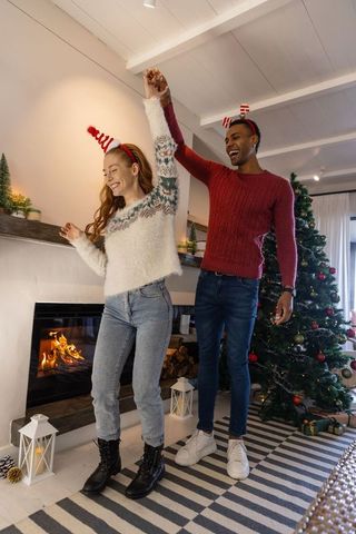 Couple Dancing in Festive Living Room During Holiday Season