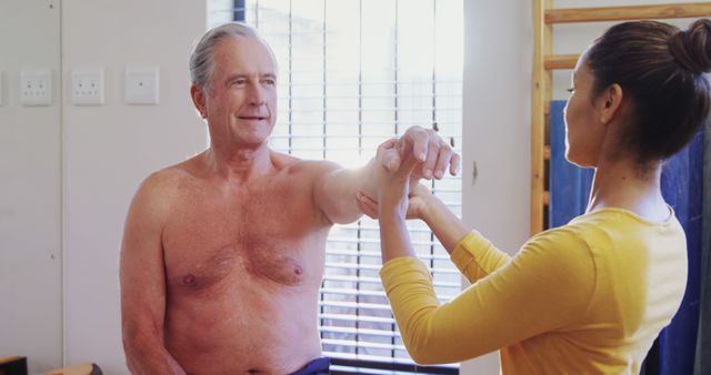 Physical Therapist Assisting Senior Male Patient with Shoulder Exercise - Download Free Stock Images Pikwizard.com